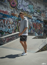 Model wearing All-Over Print Unisex Athletic Long Shorts
